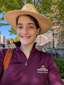 Student Addie Engebretson poses for a headshot. She is smiling and wearing a Minnesota School of Public Health jacket. 